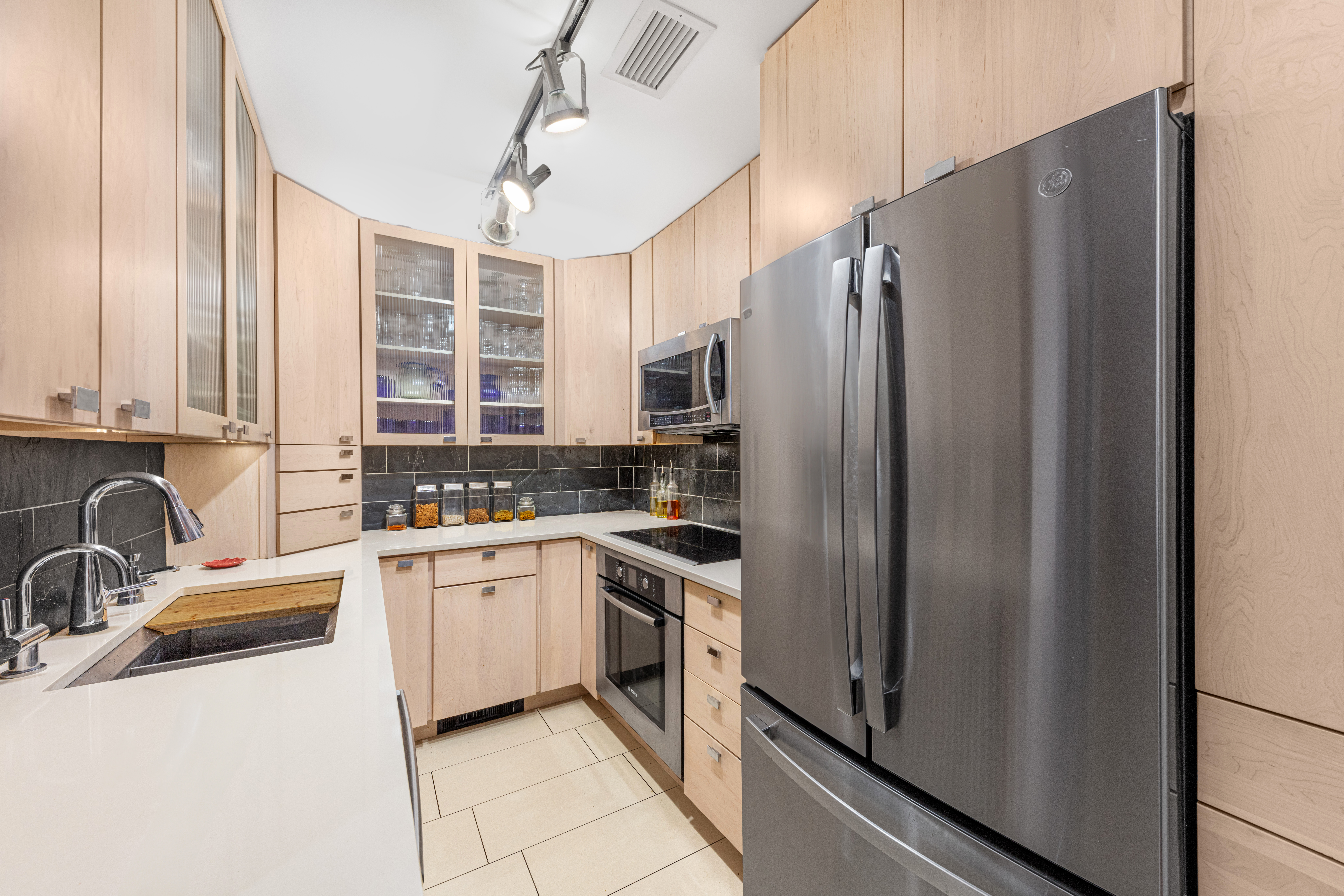 129 Barrow Street, Unit GA Manhattan, NY 10014 - Photo 4 of 17 a kitchen with stainless steel appliances granite countertop a refrigerator and a sink