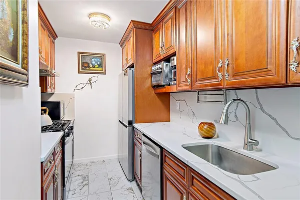 a kitchen with a sink a stove and cabinets
