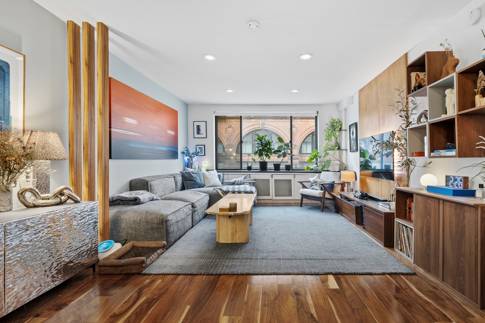 179 Grand Street, Unit 2F Manhattan, NY 10013 - Photo 2 of 11 a living room with furniture and a wooden floor