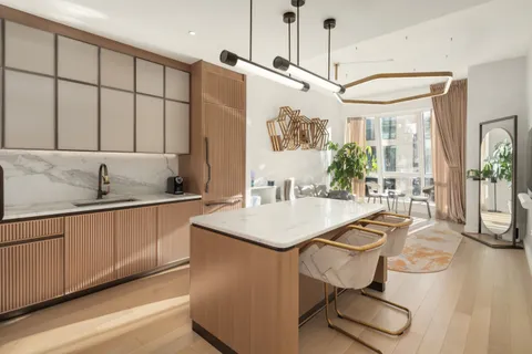a kitchen with stainless steel appliances a sink a counter top space cabinets and a window
