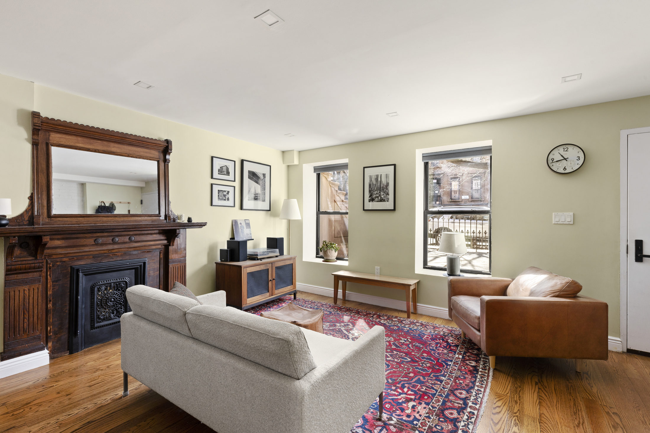437 Putnam Avenue, Unit 1 Brooklyn, NY 11221 - Photo 1 of 12 a living room with furniture wooden floor and a flat screen tv