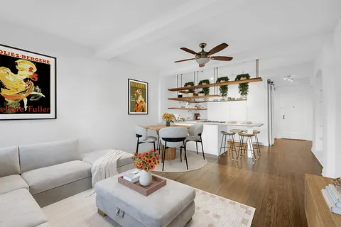 a living room with furniture and kitchen view