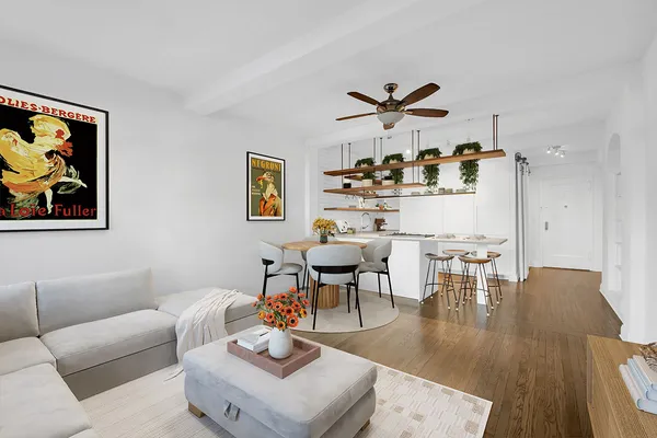 a living room with furniture and kitchen view