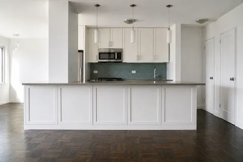 a view of kitchen with wooden floor