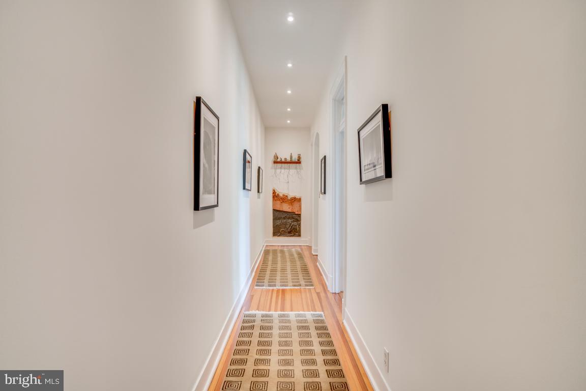 2415 20th Street Northwest, Unit 38 Washington, DC 20009 - Photo 15 of 30 a view of a hallway with wooden floor and staircase