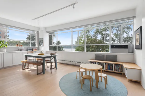 a living room with large window and furniture