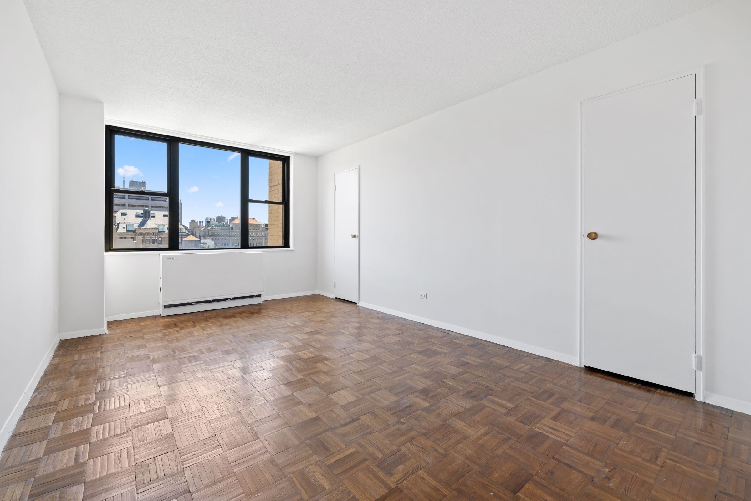 201 East 17th Street, Unit 15H Manhattan, NY 10003 - Photo 14 of 24 an empty room with windows