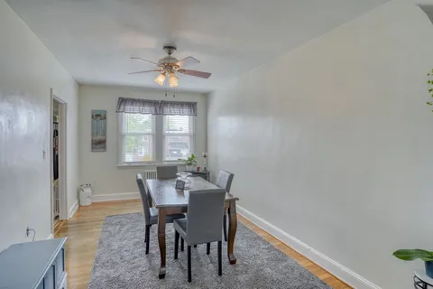 a dining room with furniture a chandelier and window