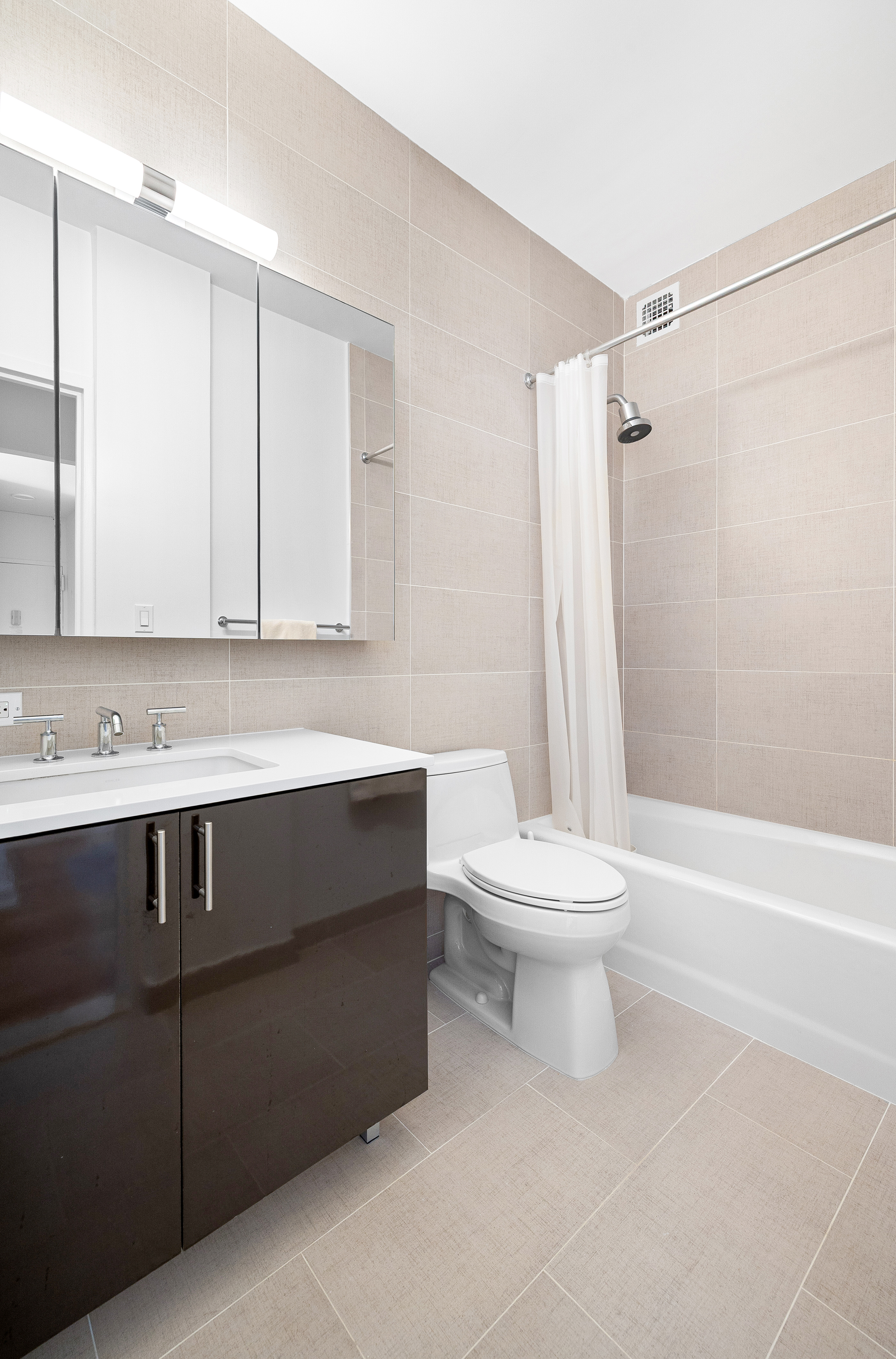 60 East 8th Street, Unit 15P Manhattan, NY 10003 - Photo 8 of 17 a bathroom with a sink a toilet and shower