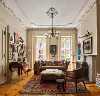 a living room with furniture a rug and a chandelier