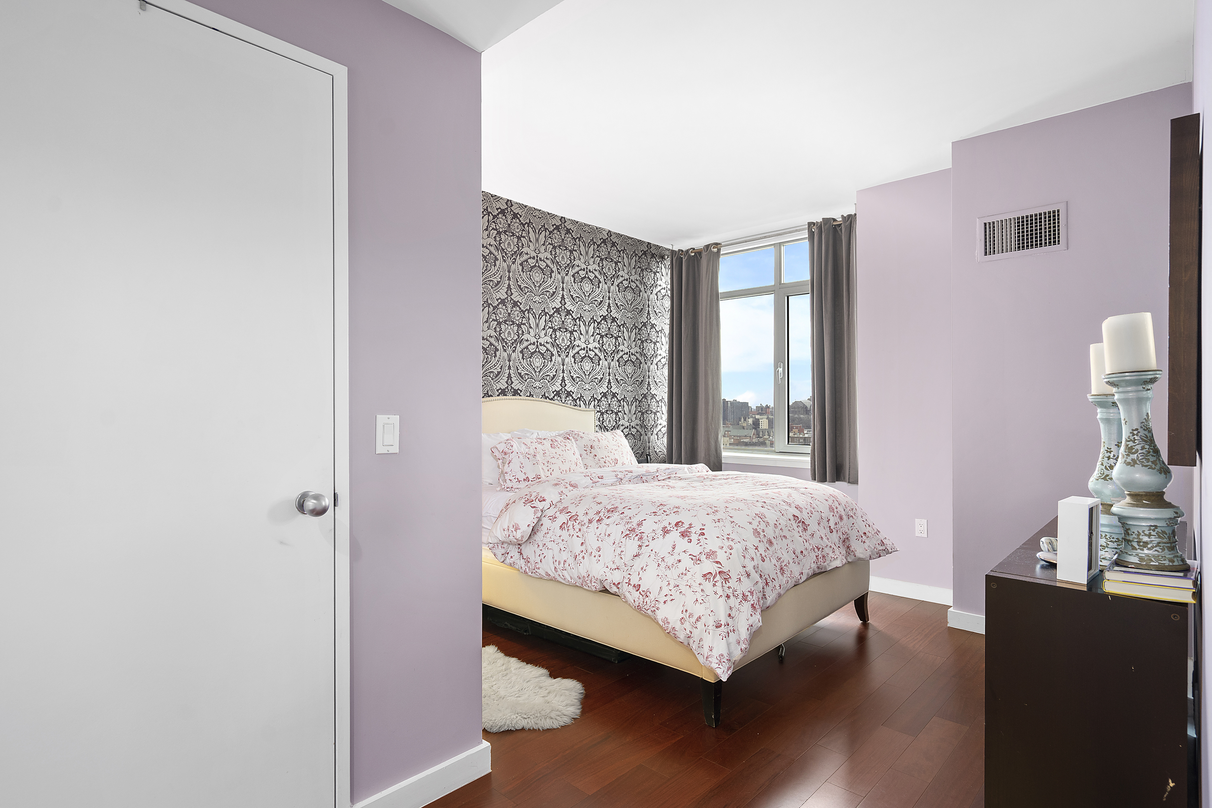 1485 5th Avenue, Unit 18/19H Manhattan, NY 10035 - Photo 8 of 21 a bedroom with a bed and wooden floor