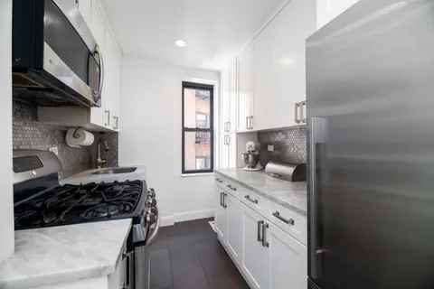 a kitchen with stainless steel appliances granite countertop a stove and a sink