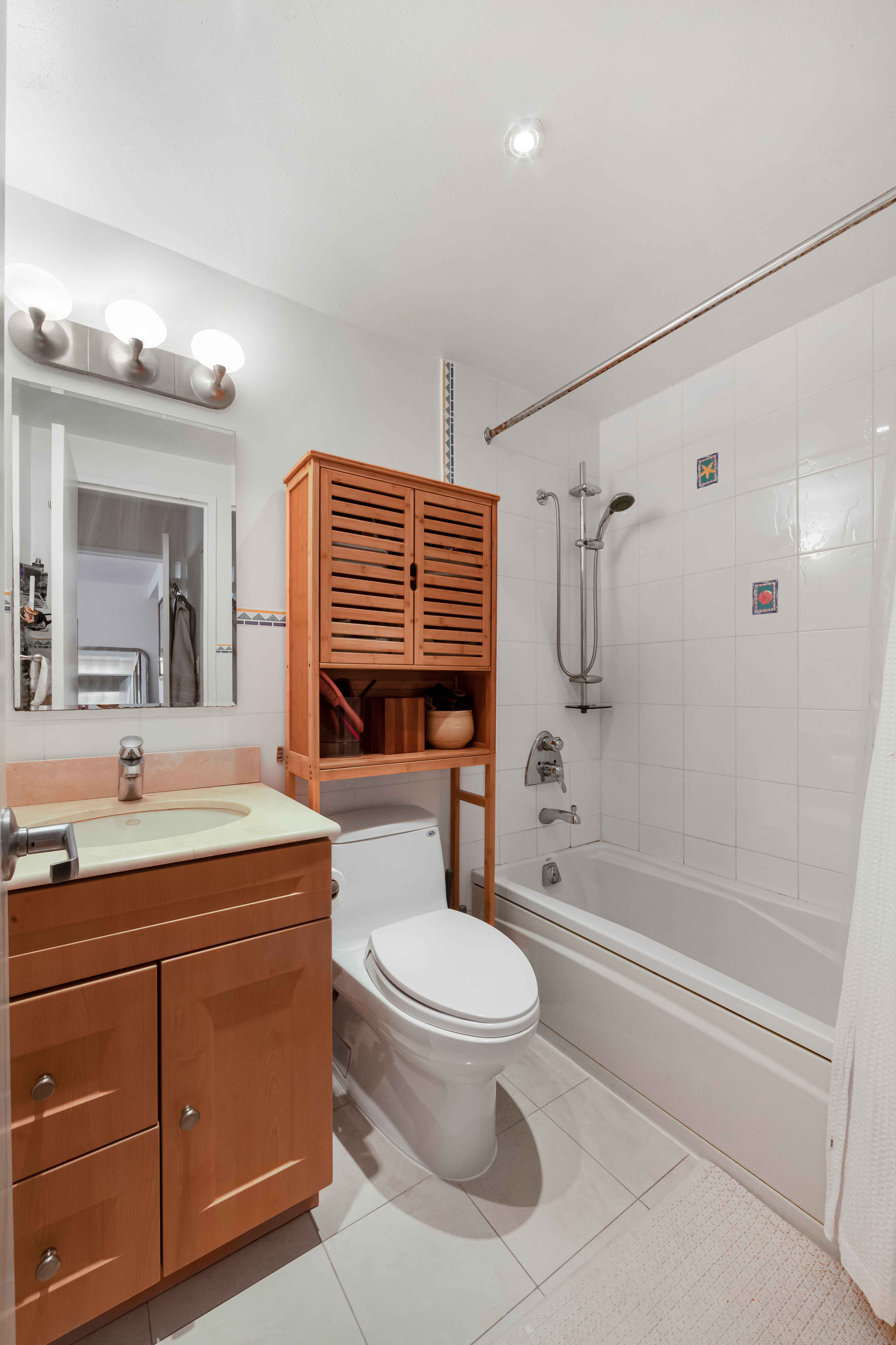 50 Lexington Avenue, Unit 10D Manhattan, NY 10010 - Photo 7 of 12 a bathroom with a sink a toilet and shower