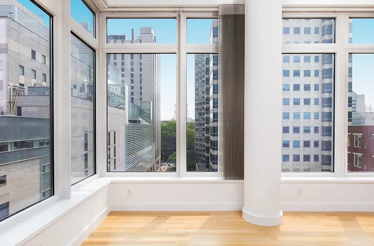 400 East 67th Street, Unit 7G Manhattan, NY 10065 - Photo 2 of 20 a view of balcony with a large window and wooden floor