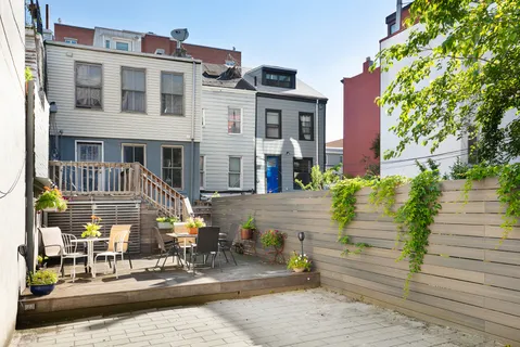 a front view of a building with a garden