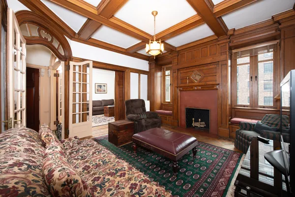 a living room with furniture a rug and a fireplace