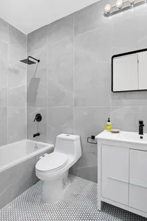 a bathroom with a sink a toilet and bathtub