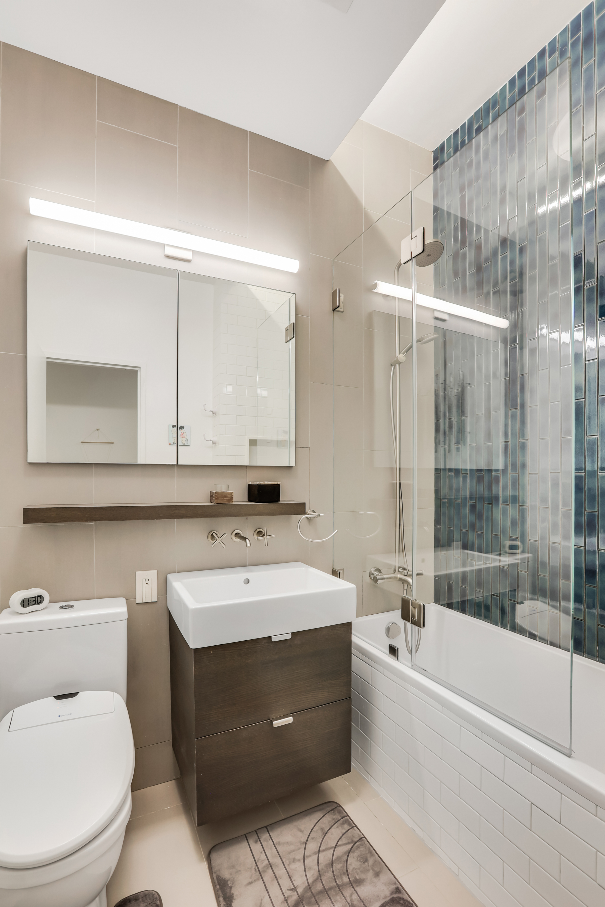 310 East 46th Street, Unit 10S Manhattan, NY 10017 - Photo 8 of 10 a bathroom with a sink a toilet and a bathtub