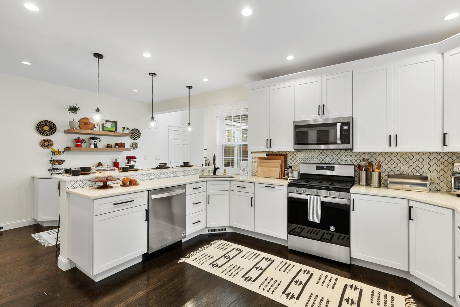 1 Maple Street, Unit 1 Maynard, MA 01754 - Photo 12 of 42 a kitchen with a sink stove and white cabinets