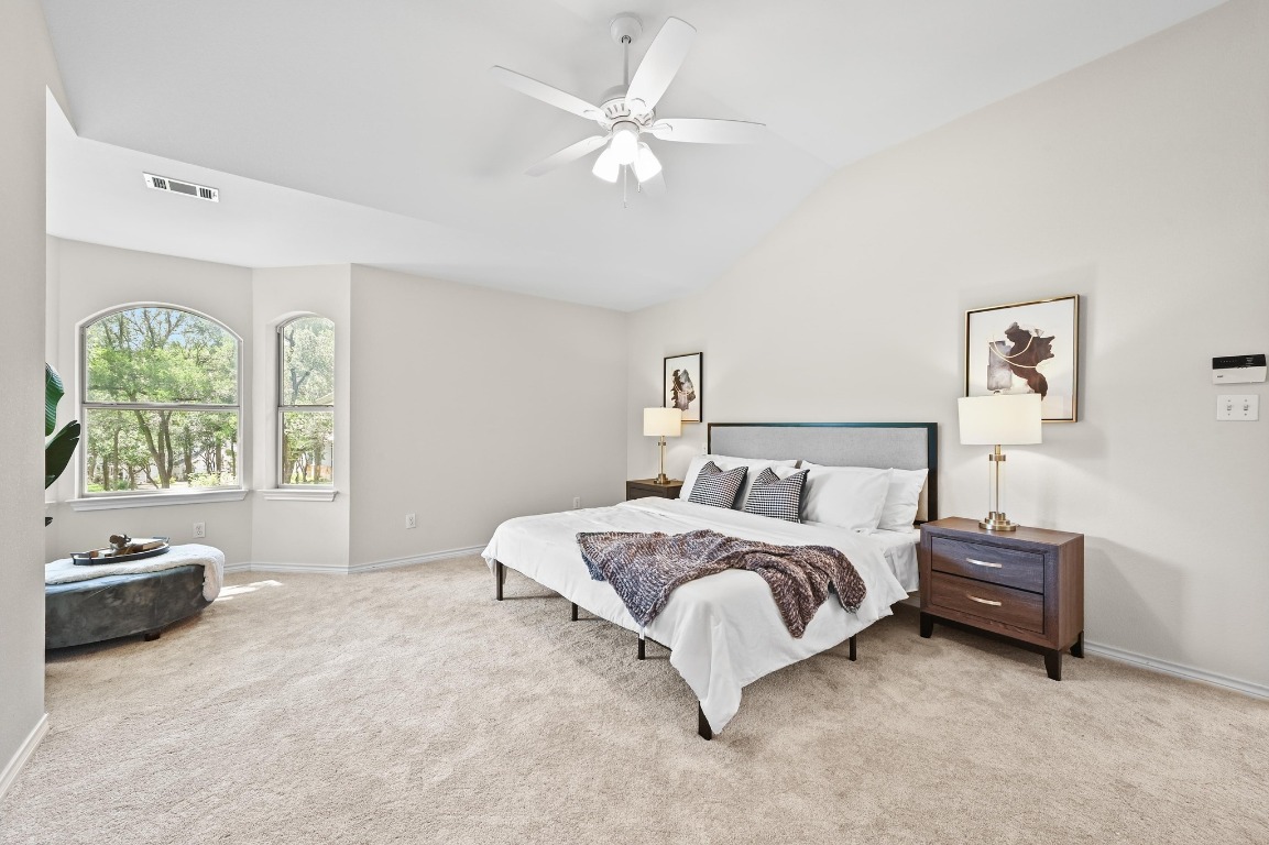 111 Trinity Street Cedar Creek, TX 78612 - Photo 17 of 38 a spacious bedroom with a bed and a window