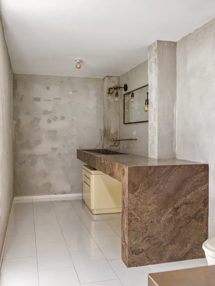 a bathroom with a granite countertop sink a mirror and shower