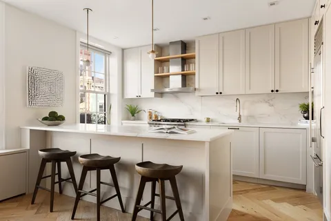 a kitchen with stainless steel appliances white cabinets and a sink