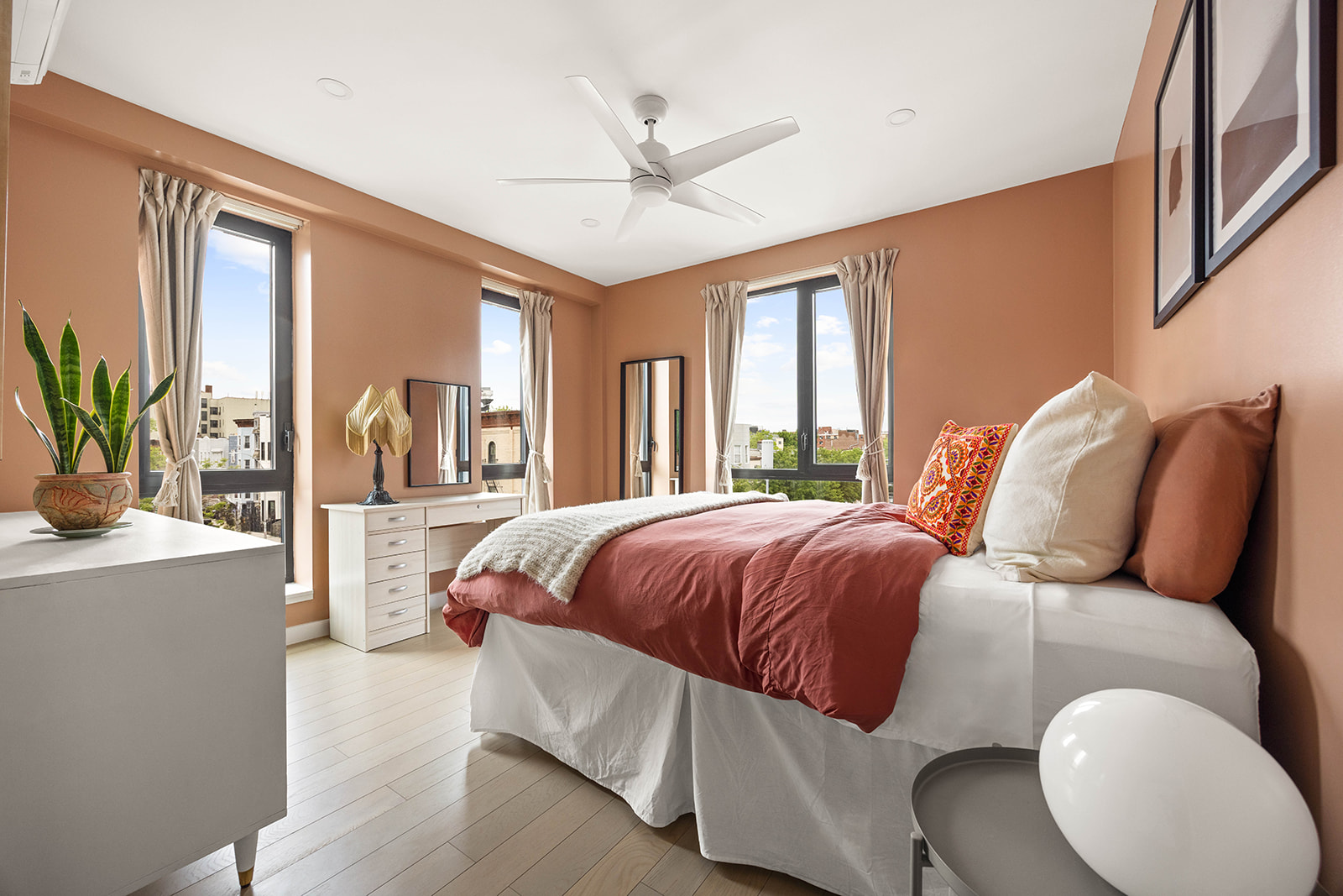 a bedroom with a large bed and a large window