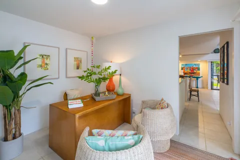 a living room with furniture and a potted plant