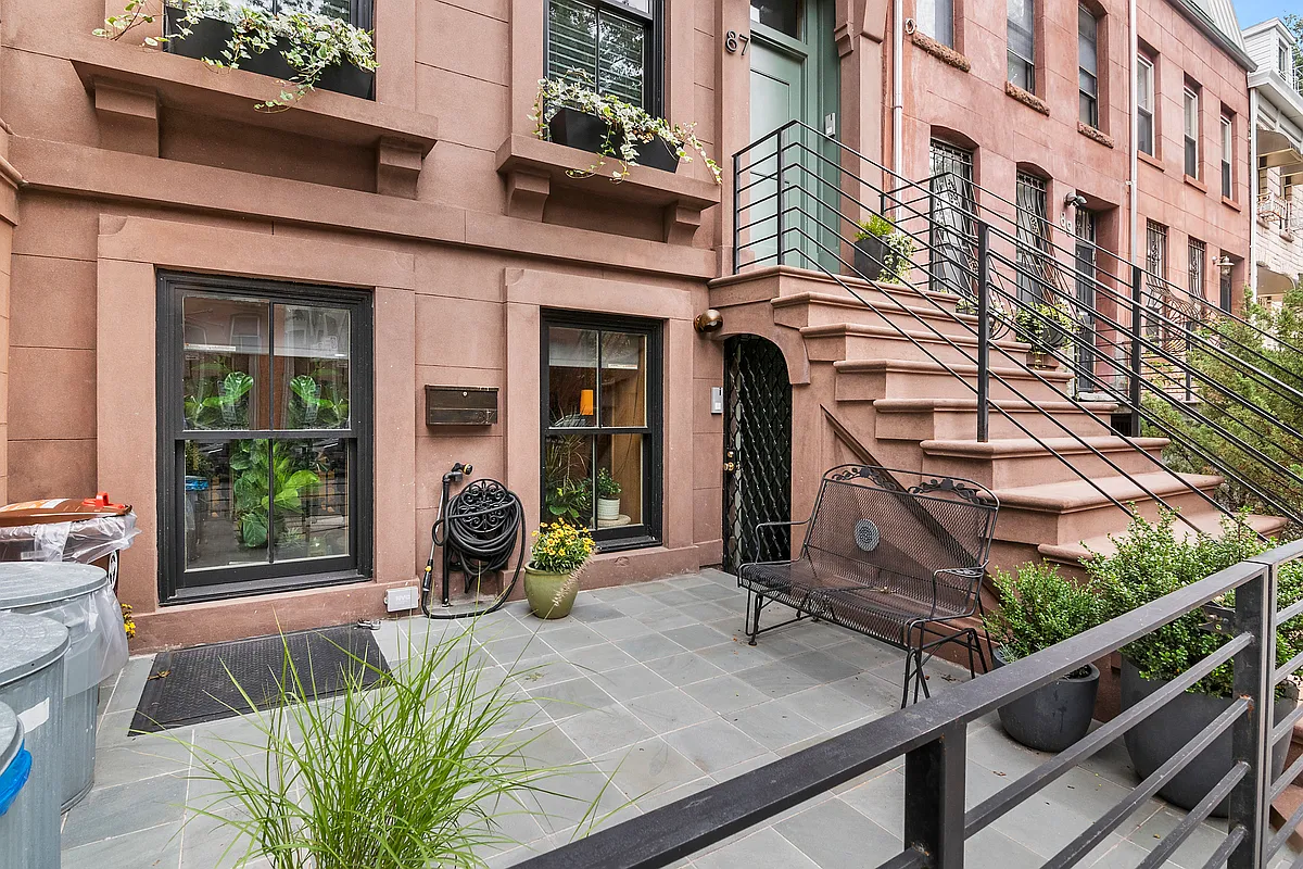 87 Monroe Street, Unit 1 Brooklyn, NY 11216 - Photo 10 of 11 a front view of a building with garden