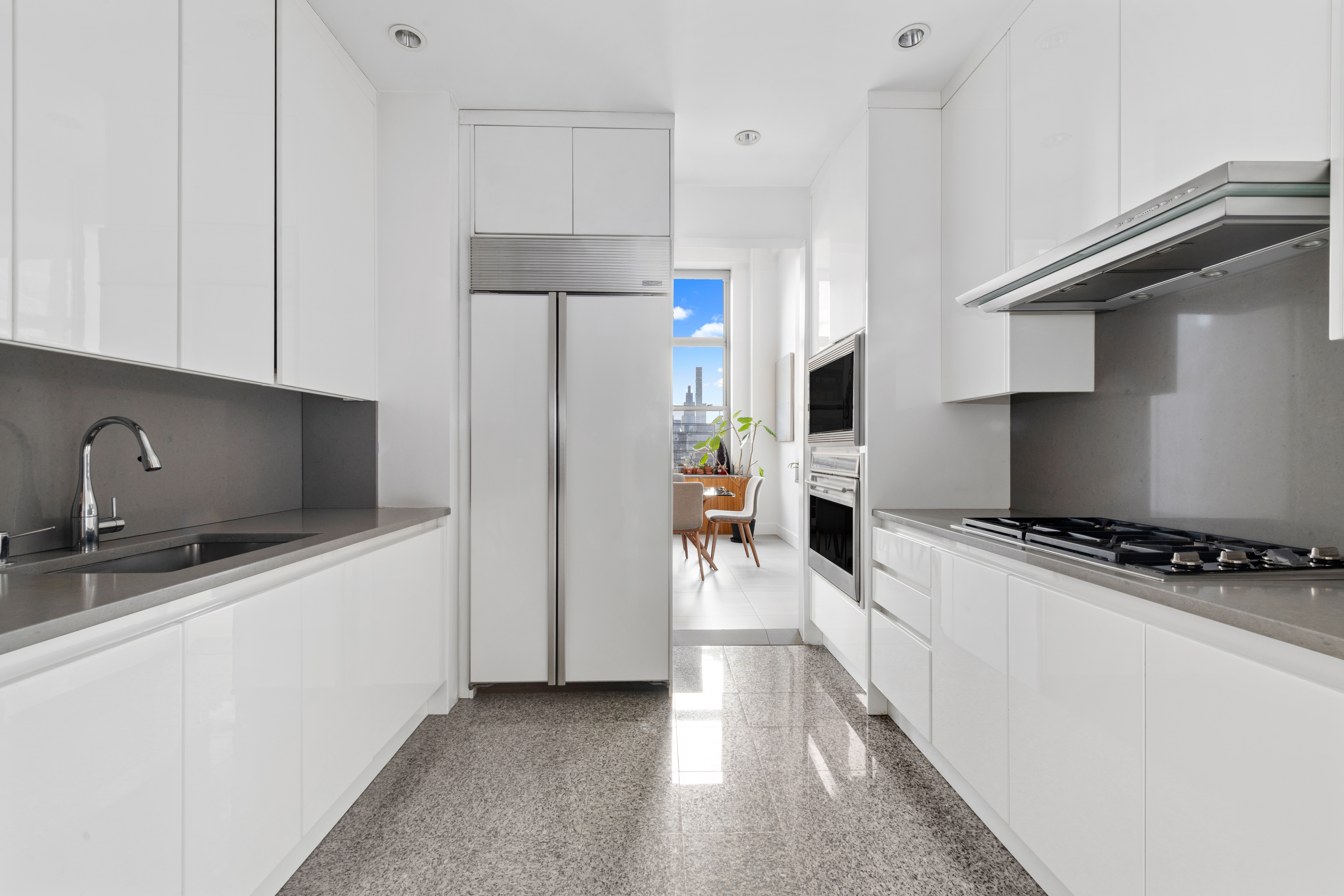 120 East 87th Street, Unit R16G Manhattan, NY 10128 - Photo 6 of 20 a kitchen with stainless steel appliances a refrigerator a stove a sink and white cabinets
