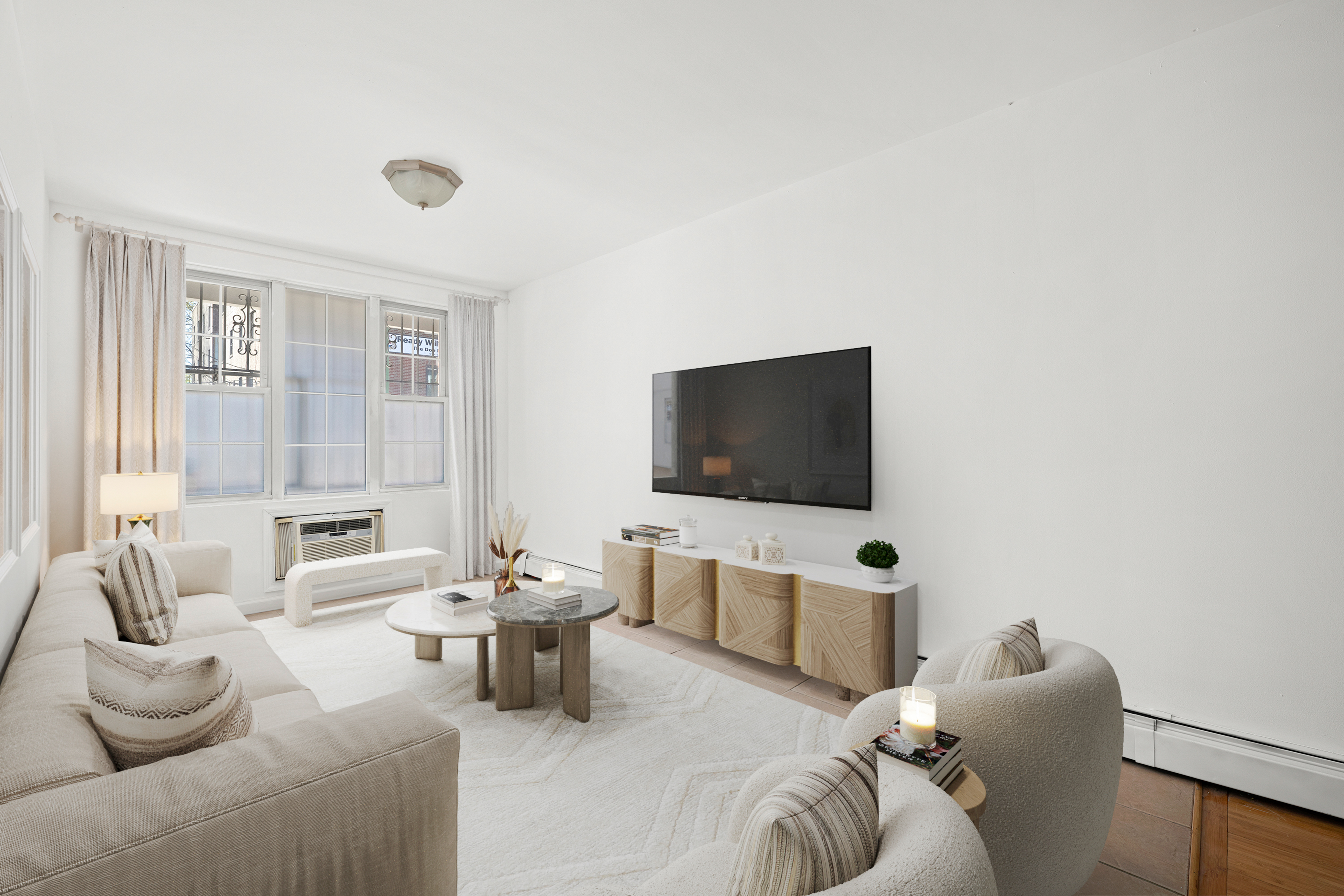 545 Gates Avenue, Unit 1 Brooklyn, NY 11216 - Photo 2 of 10 a living room with furniture and a flat screen tv