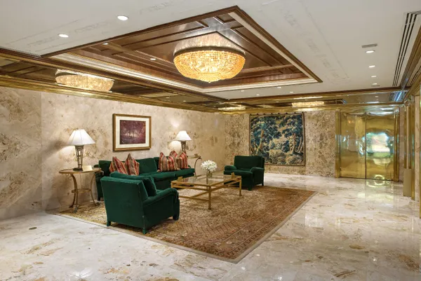 a living room with furniture a lamp and a clock