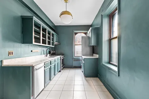 a kitchen with a cabinets and window