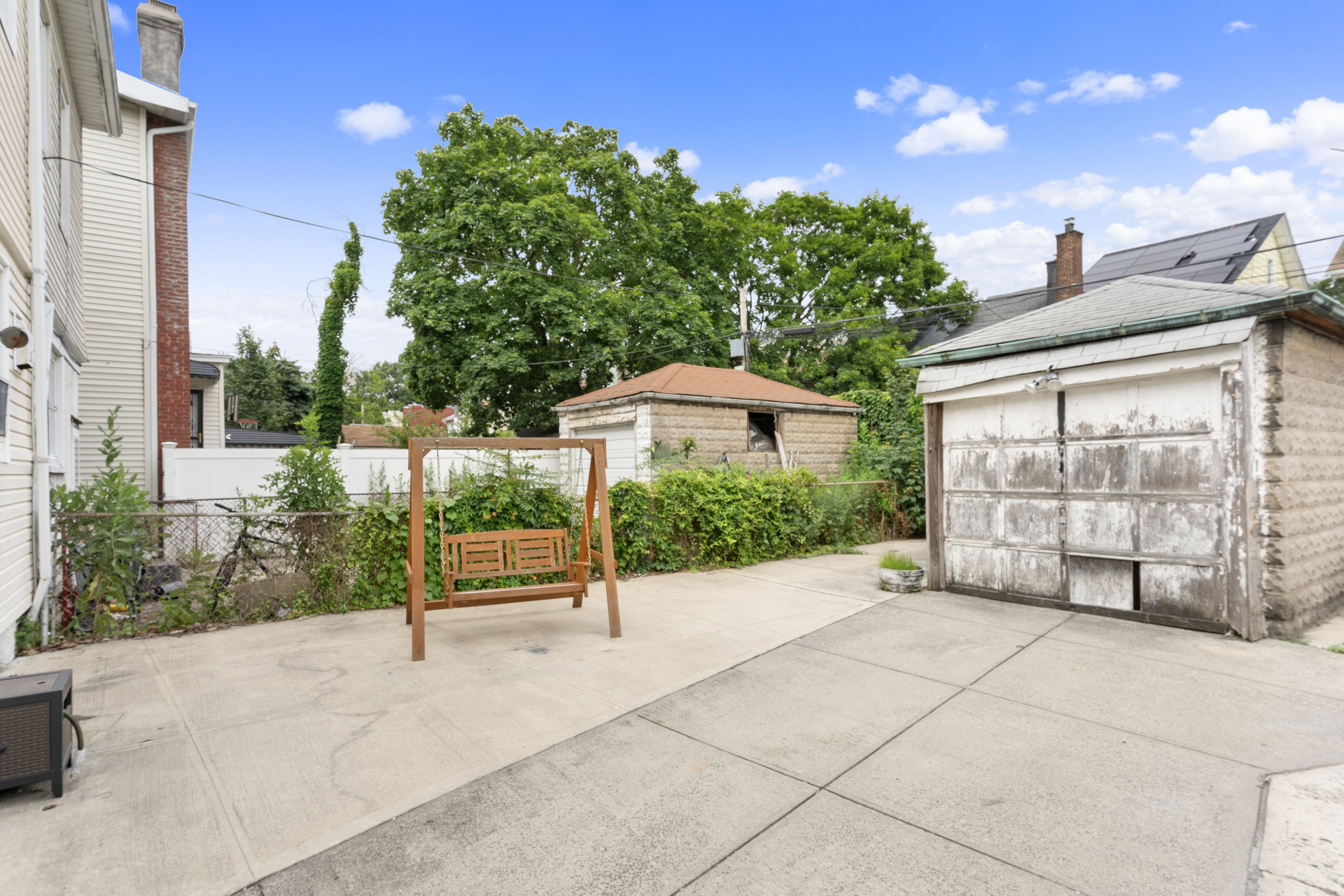 1065 East 39th Street Brooklyn, NY 11210 - Photo 9 of 15 a view of a bench in front of a house