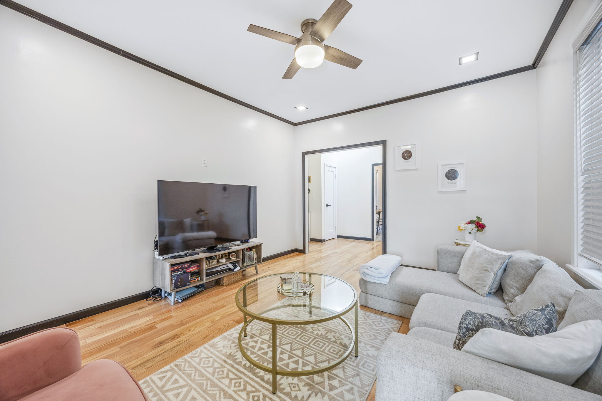 25-69 46th Street Queens, NY 11103 - Photo 12 of 33 a living room with furniture and a flat screen tv