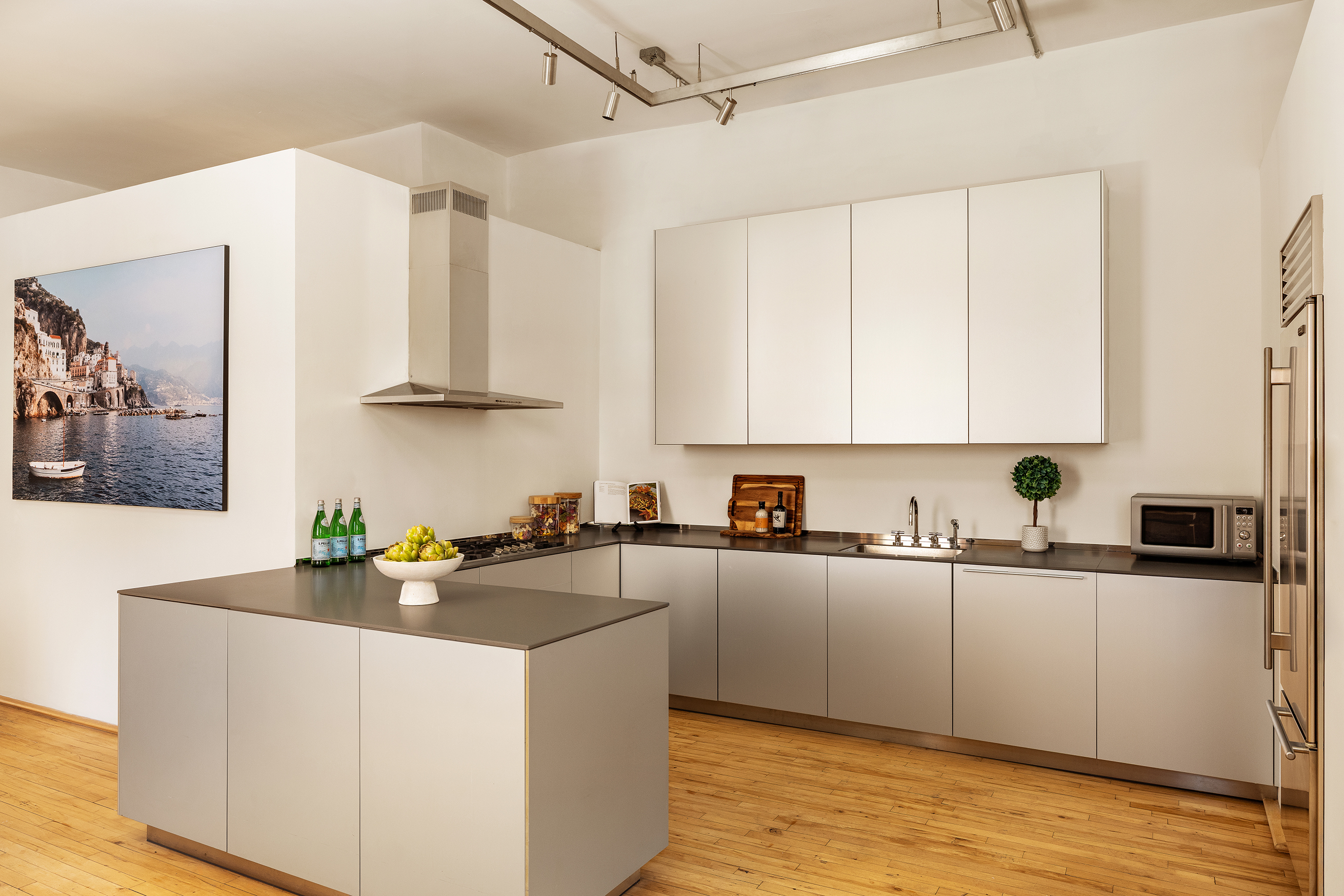 25 East 4th Street, Unit 2 Manhattan, NY 10003 - Photo 9 of 12 a kitchen with stainless steel appliances a sink a stove a refrigerator cabinets and a counter space