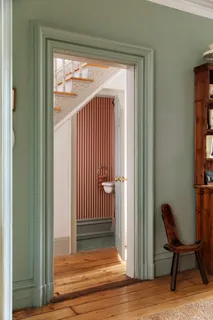 a view of a hallway with wooden floor and a swing