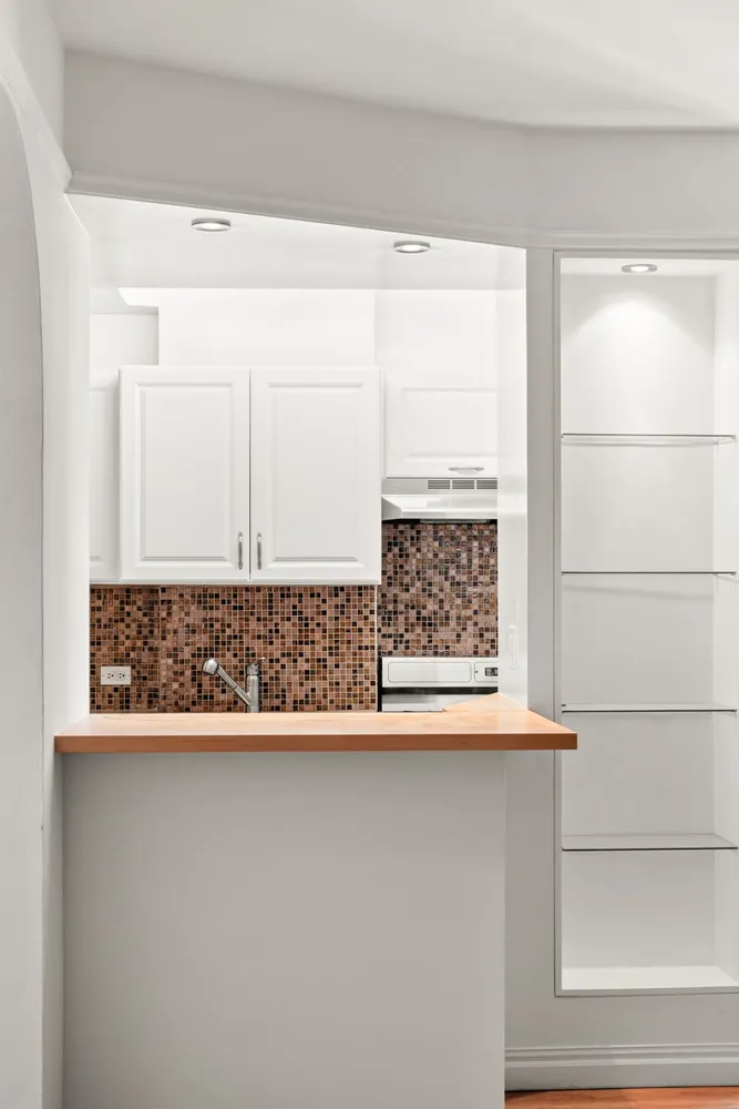 a kitchen with a sink and cabinets