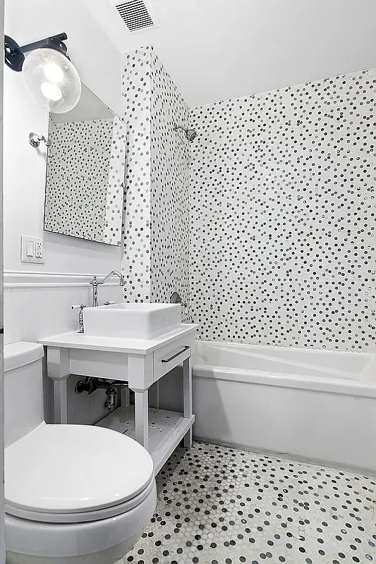 180 Bainbridge Street, Unit 311 Brooklyn, NY 11233 - Photo 5 of 21 a bathroom with a sink a toilet and a mirror