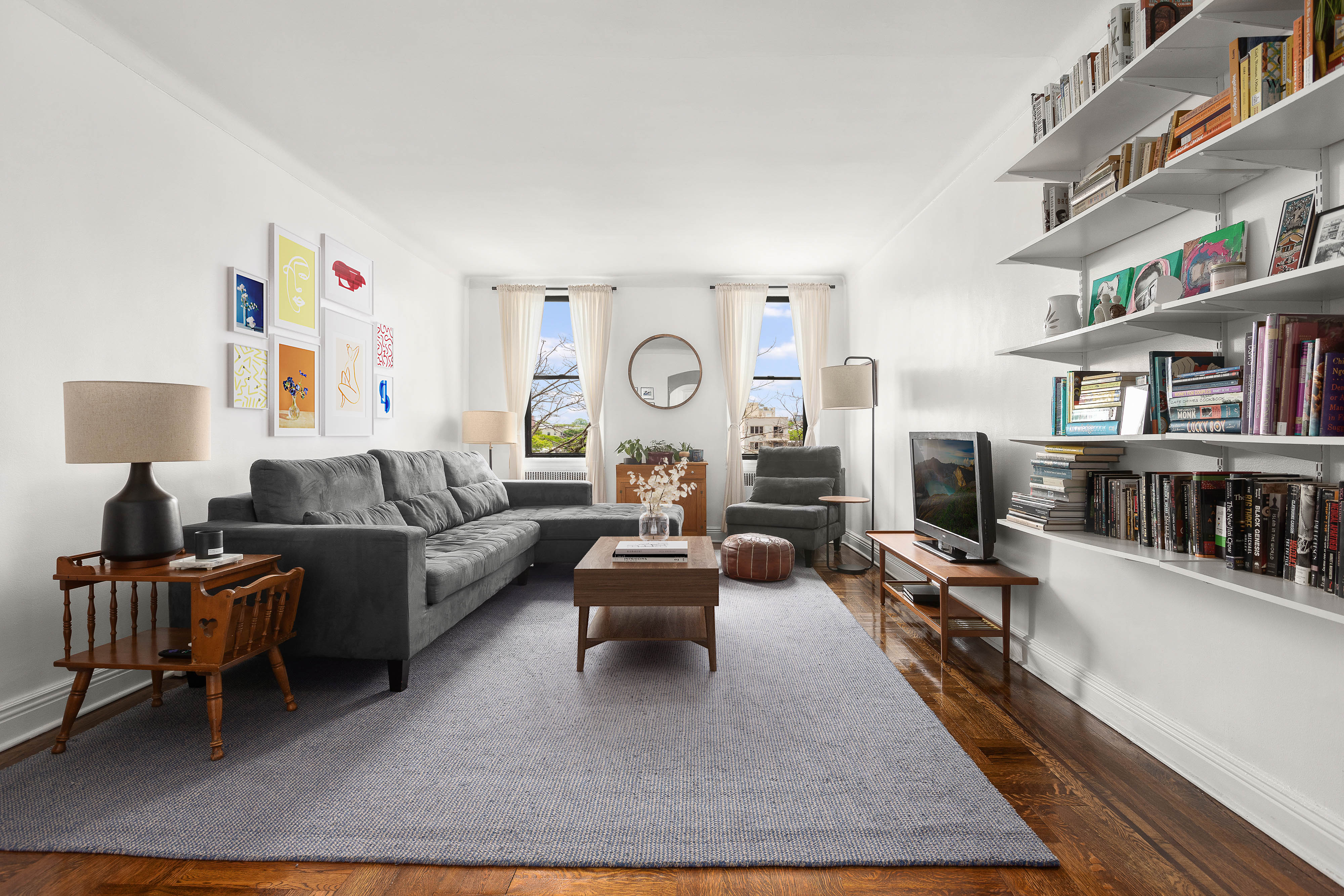 a living room with furniture and a book shelf