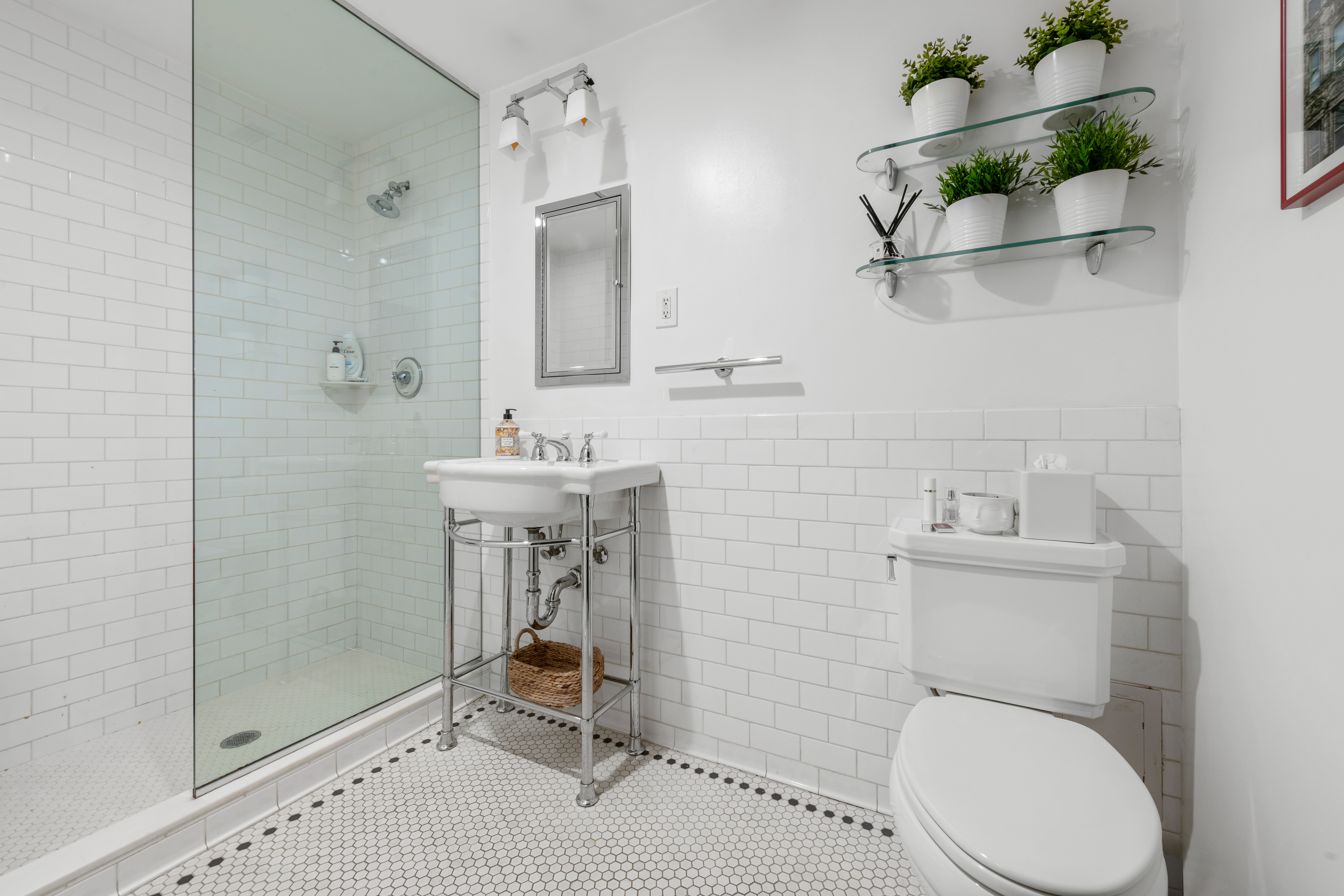 21 West 9th Street, Unit 1F Manhattan, NY 10011 - Photo 7 of 11 a bathroom with a sink toilet and a mirror
