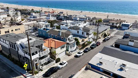 an aerial view of residential houses with outdoor space