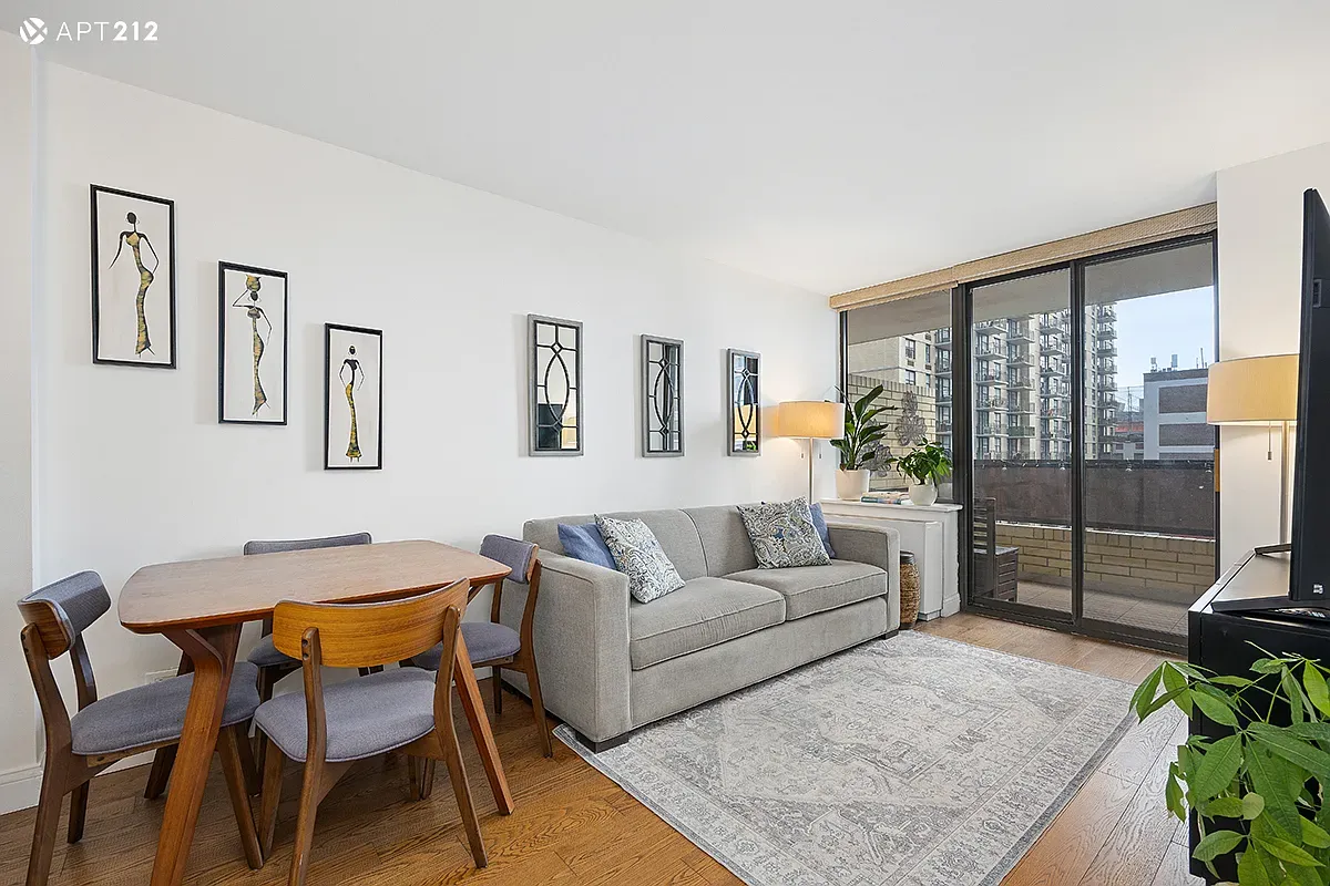 a living room with furniture and a floor to ceiling window