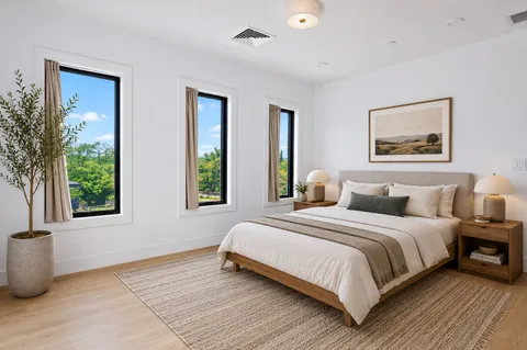 a bedroom with a large bed and a window