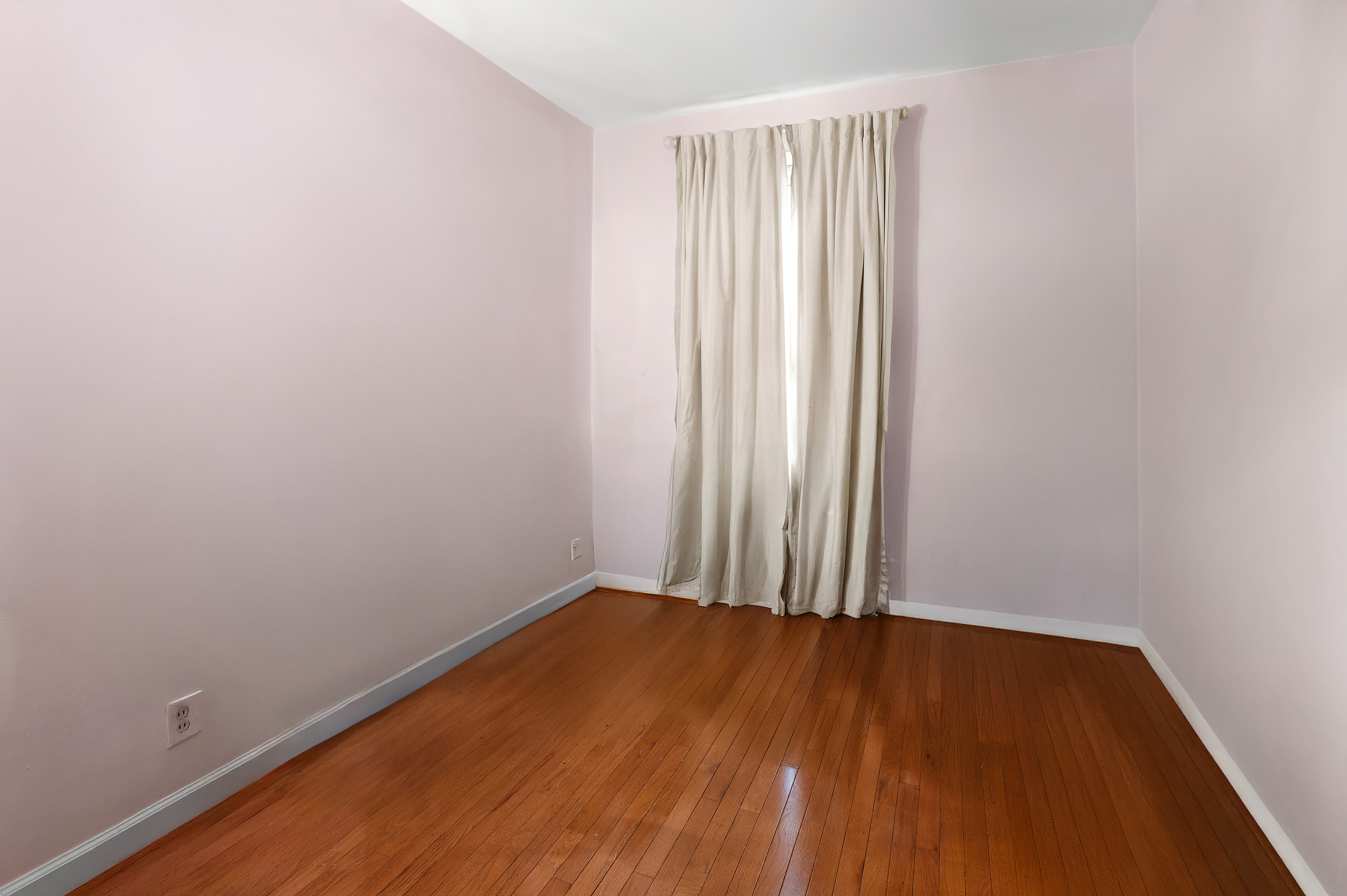 562 84th Street Brooklyn, NY 11209 - Photo 15 of 25 an empty room with wooden floor and windows