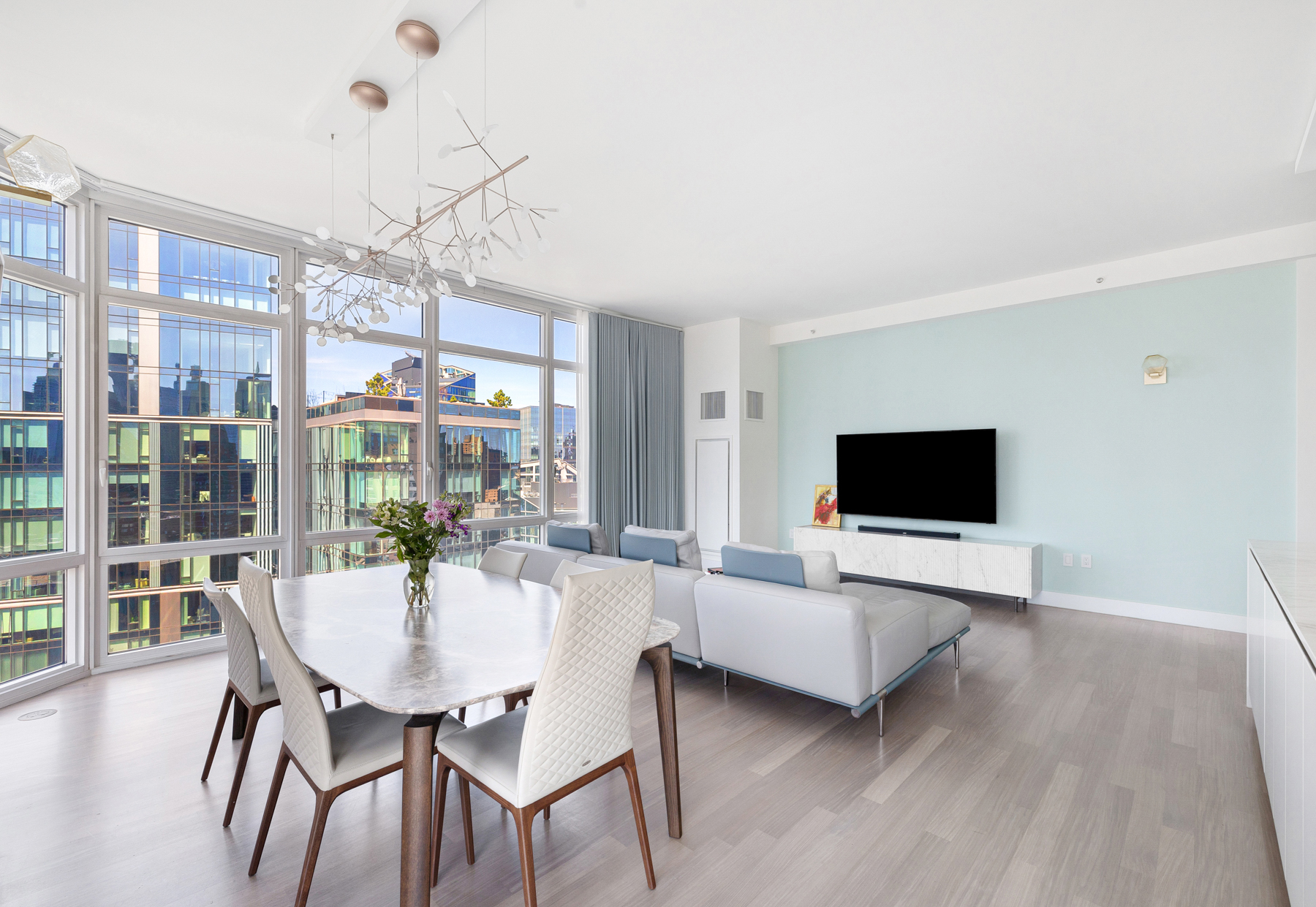 10 West End Avenue, Unit 30C Manhattan, NY 10023 - Photo 4 of 22 a view of a dining room with furniture wooden floor and chandelier
