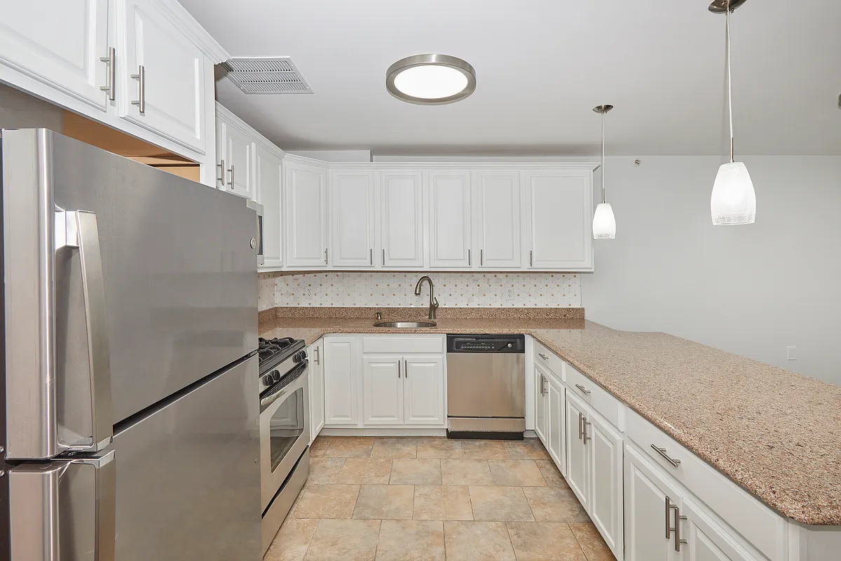 10220 Rockaway Beach Boulevard, Unit 1A Queens, NY 11694 - Photo 3 of 8 a kitchen with a sink cabinets and stainless steel appliances