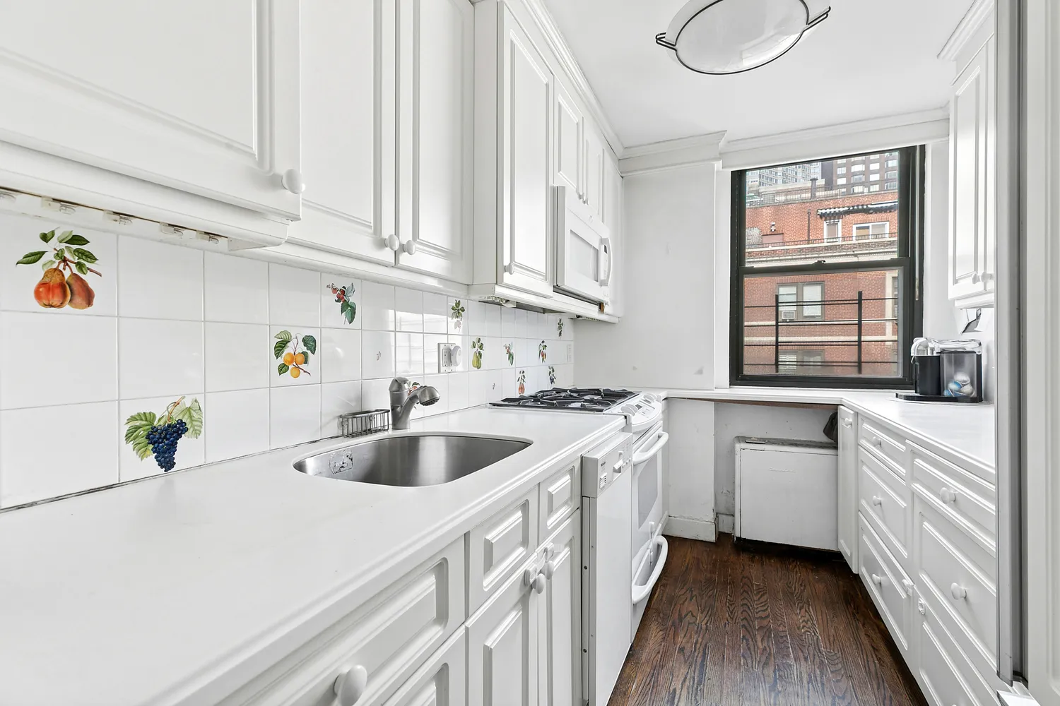 a kitchen with white cabinets and white appliances