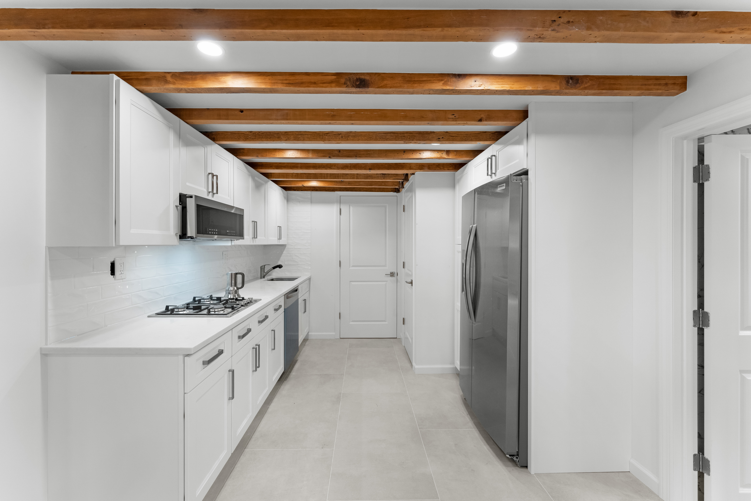 412 Fairview Avenue, Unit GARDEN Queens, NY 11385 - Photo 2 of 14 a kitchen with stainless steel appliances a white stove top oven a sink and dishwasher