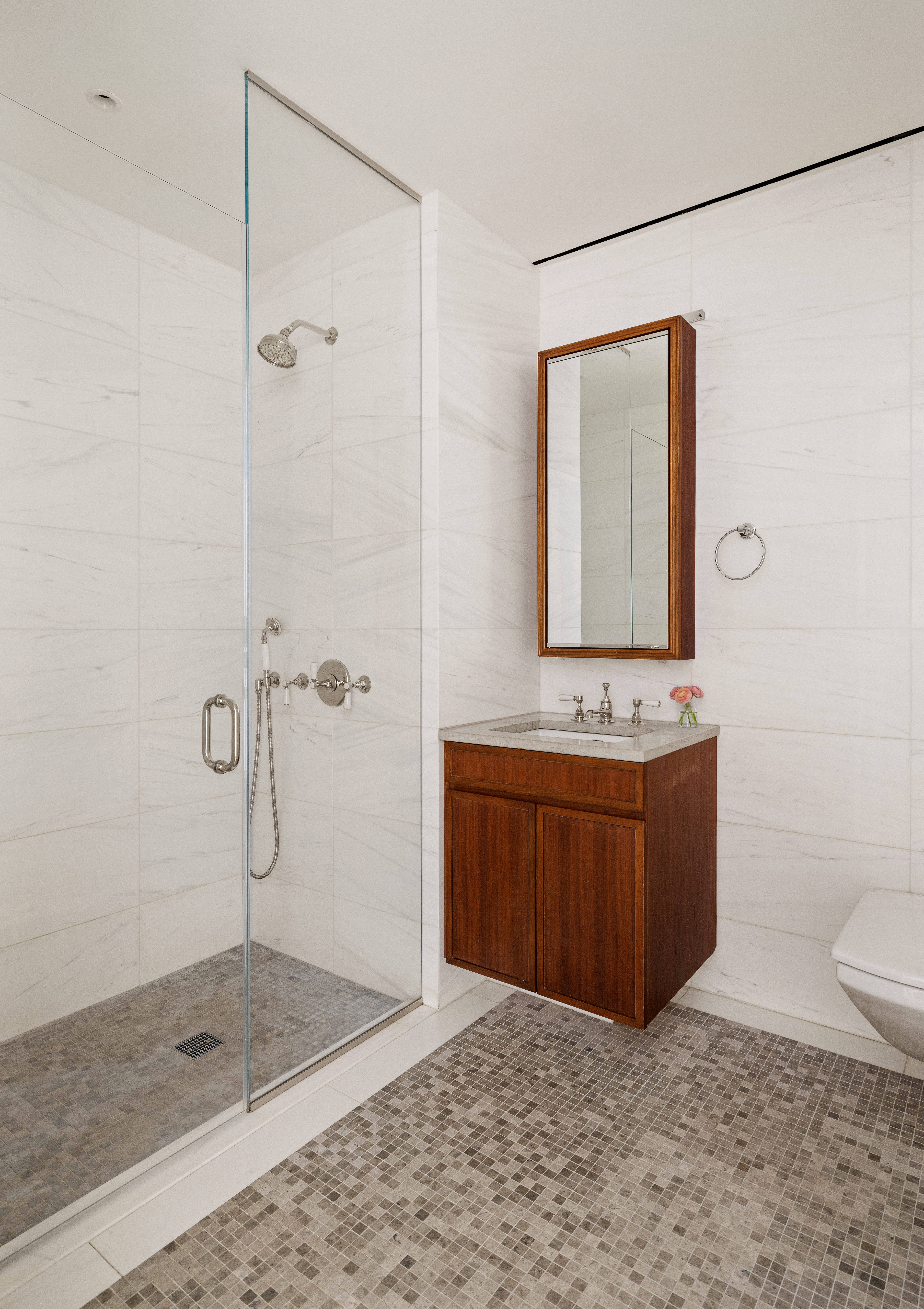 121 Nassau Street, Unit 17A Manhattan, NY 10038 - Photo 11 of 19 a bathroom with a granite countertop sink a mirror and shower